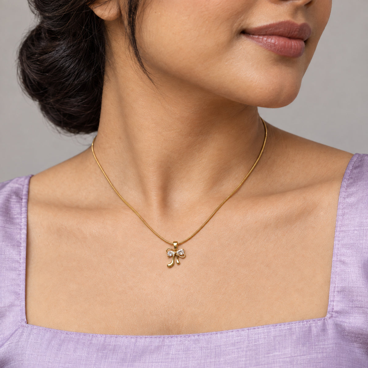 Crystal Bow Pendant Necklace worn by model