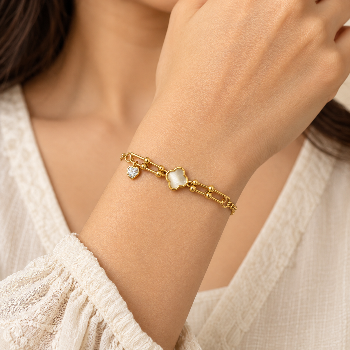 Elegant Gold Clover Bracelet with Heart Charm — model photo