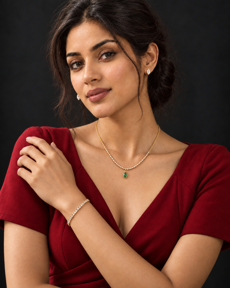 Sira wearing Ranivaa's delicate green pendant necklace, pear-shaped earrings and crystal bracelet